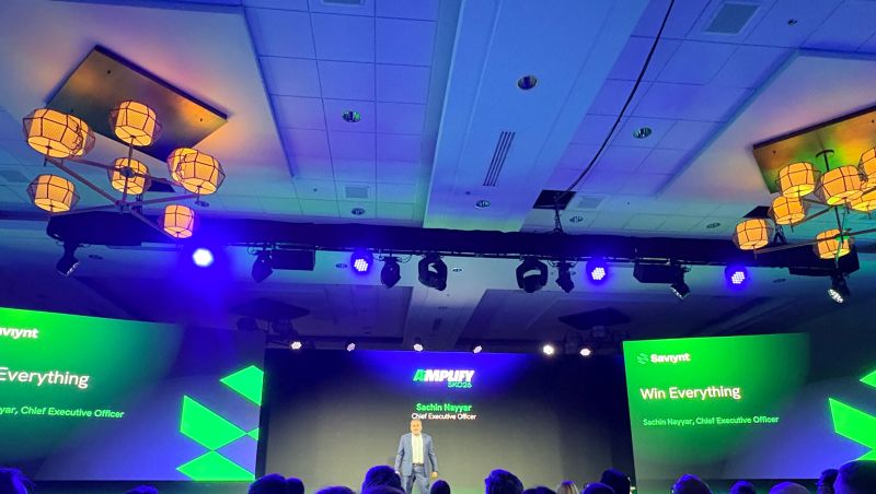 Sachin Nayyar on stage beneath Saviynt AiMPLIFY 2026 screens