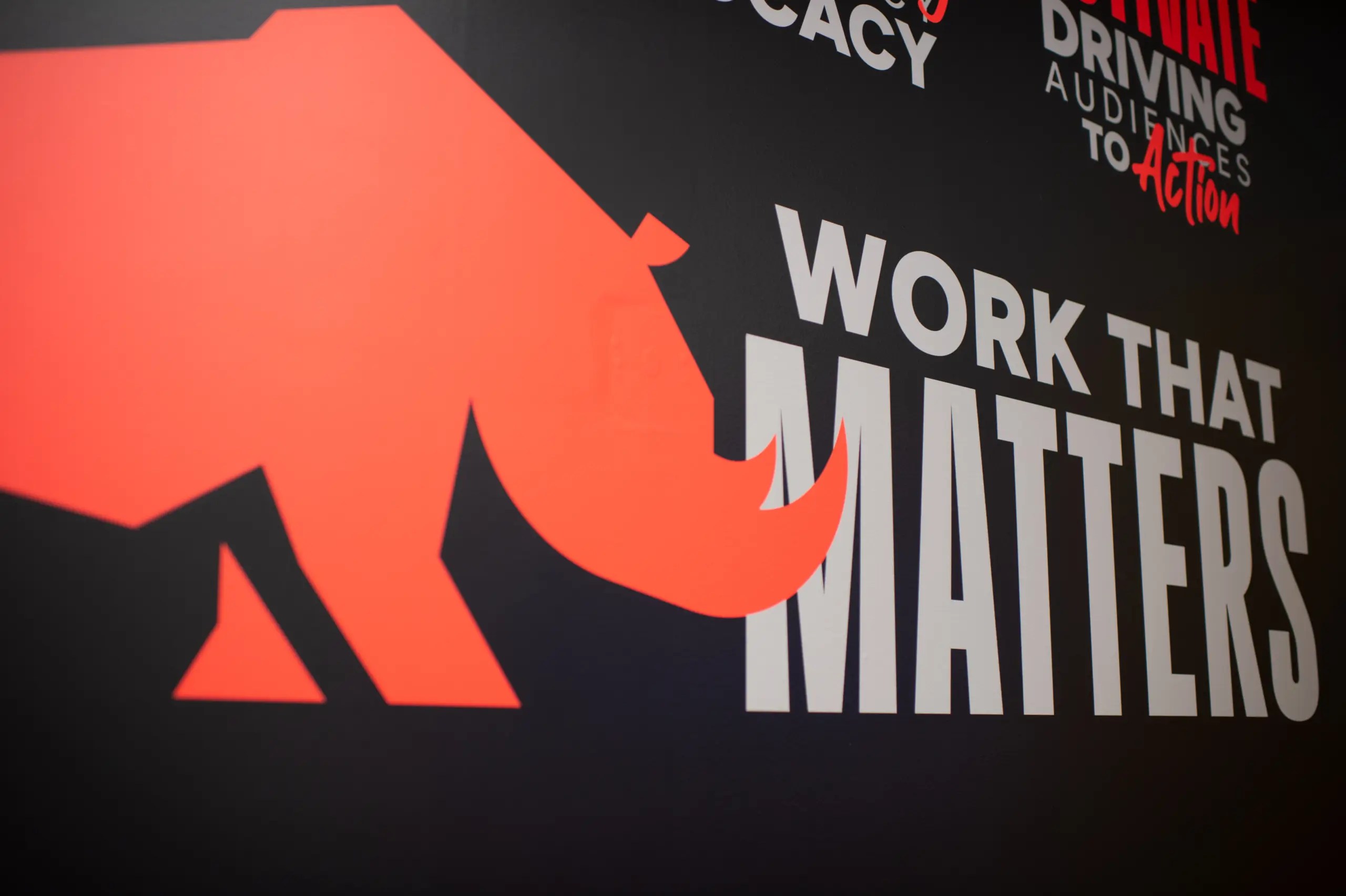 A red rhinoceros mural inside the Sachs Media office beside the words Work That Matters