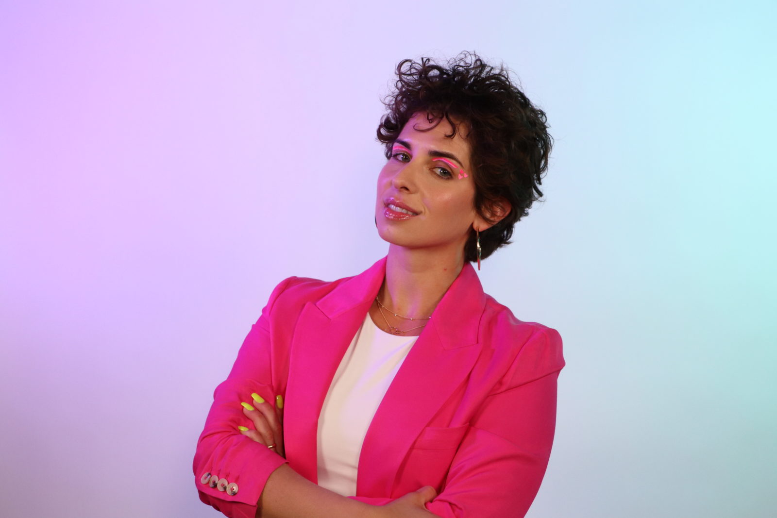 Sadie Kurzban in a vivid pink jacket against a softly colored background