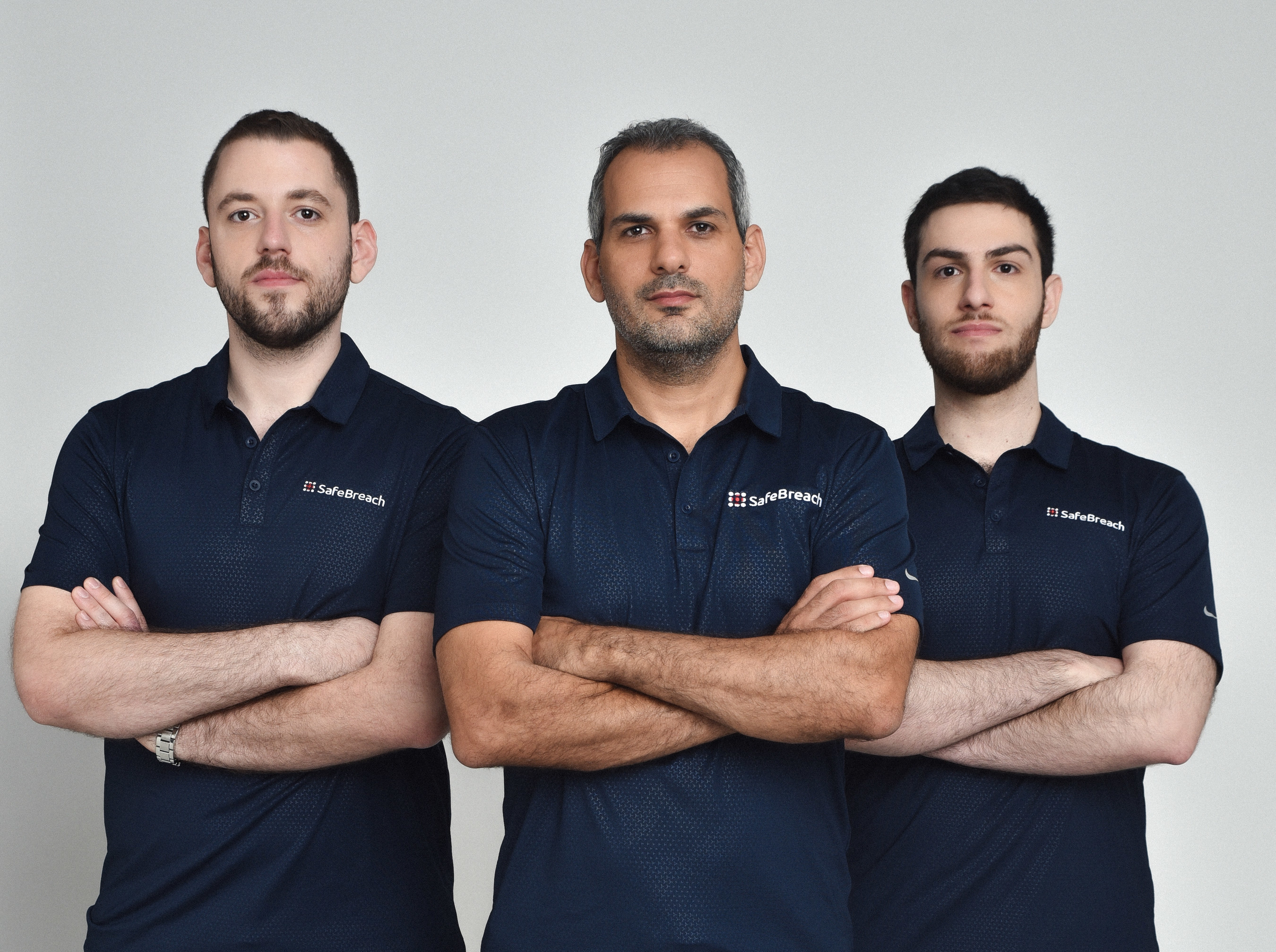 Three SafeBreach security researchers in company shirts