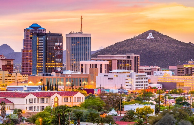 Tucson skyline at sunset, with buildings and mountains
