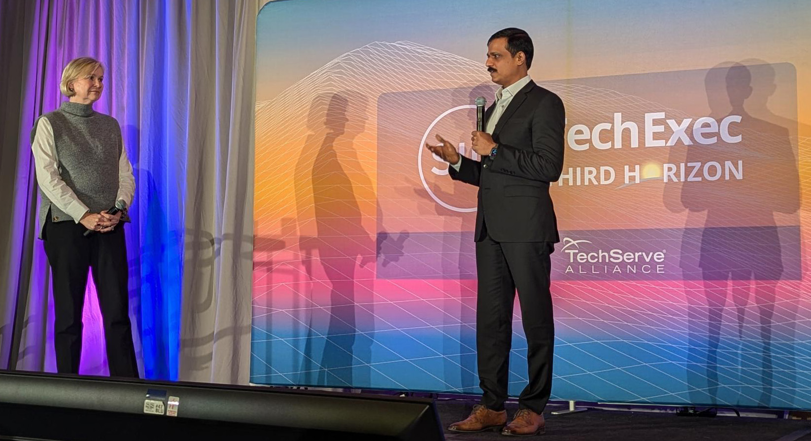 Sagar Pelaprolu speaking with Joan Holman onstage at SIM TechExec 2024