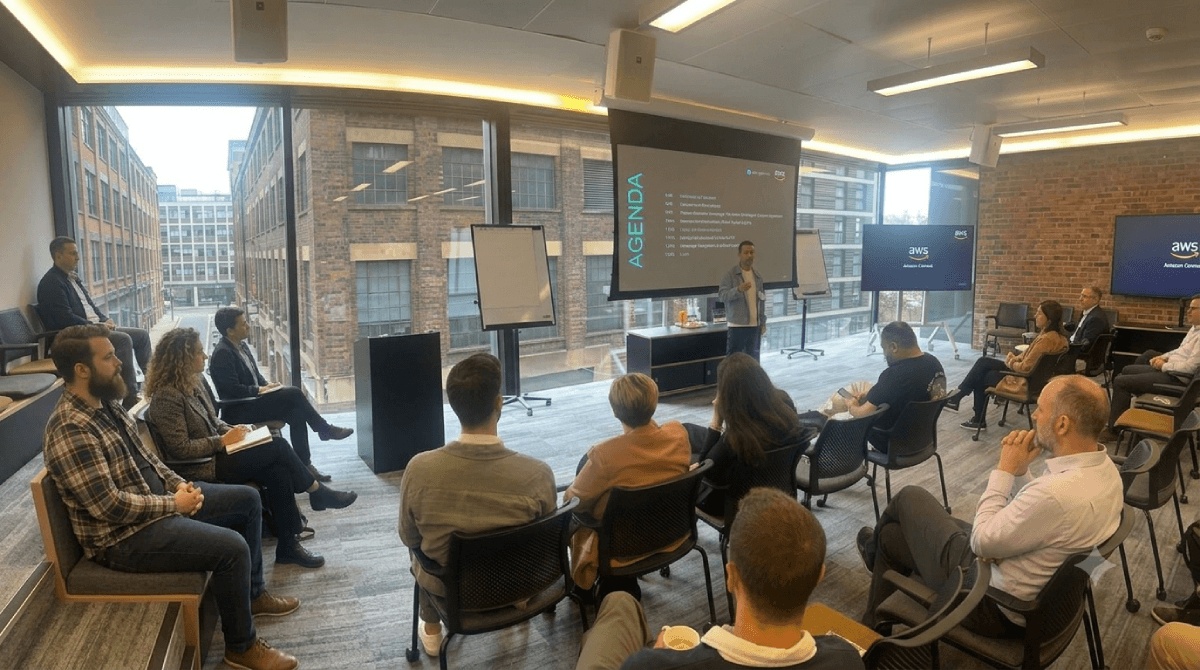 Sagi Eliyahu presenting to seated attendees at the Connect Your Knowledge London 2026 event with Amazon