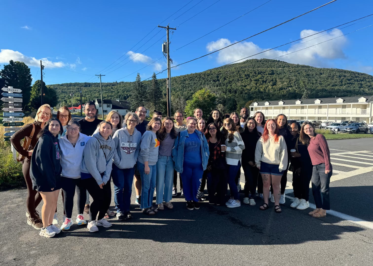 Handspring team members gathered outdoors with the Catskill Mountains behind them