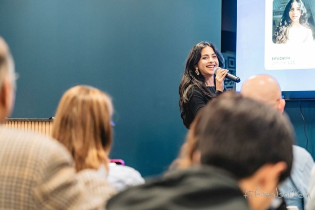 Simera co-founder Sofia Castillo speaking into a microphone at an event
