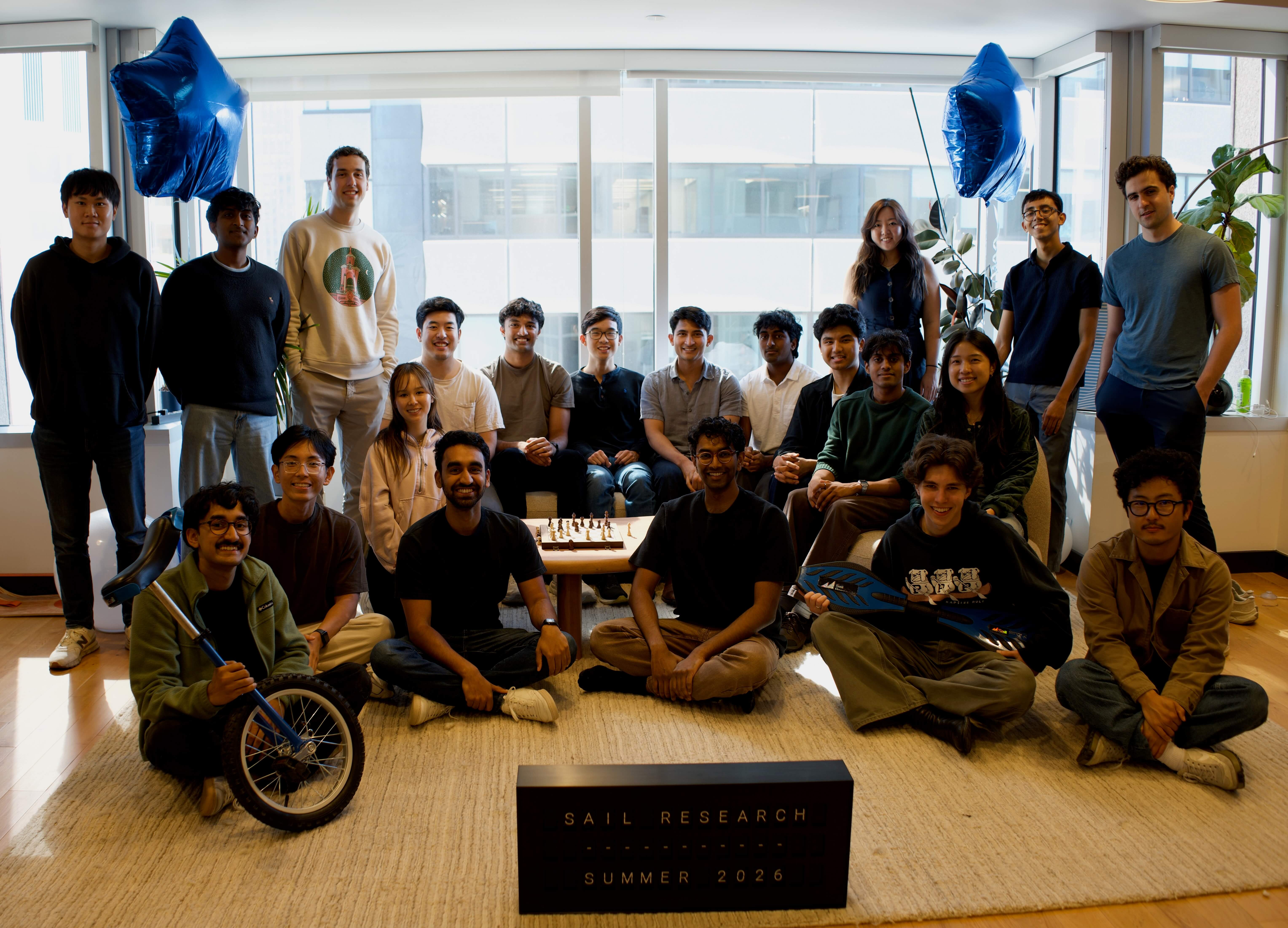The Sail Research team gathered around a chessboard in summer 2026