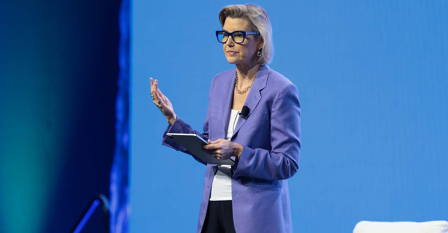 Sallie Krawcheck speaking onstage in a lavender blazer at Wealth Management EDGE in 2023