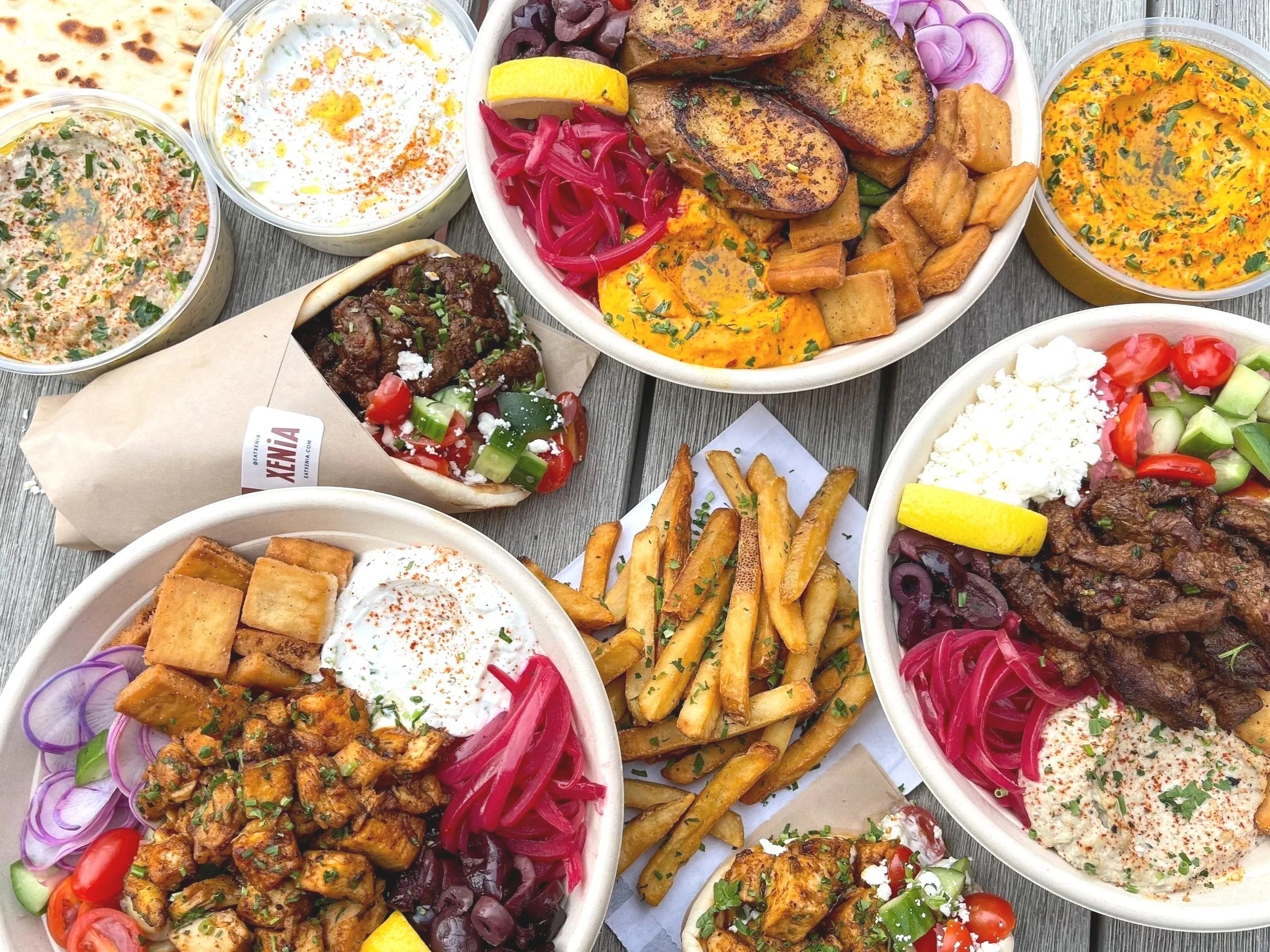 Xenia Mediterranean bowls, a filled pita, fries, and house-made dips