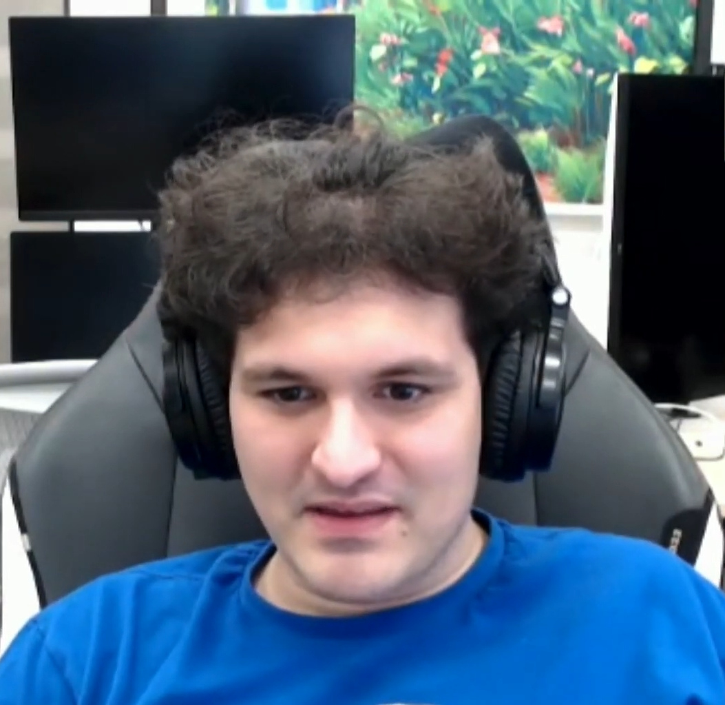 Sam Bankman-Fried wearing headphones during a video appearance at the MIT Bitcoin Expo in 2022