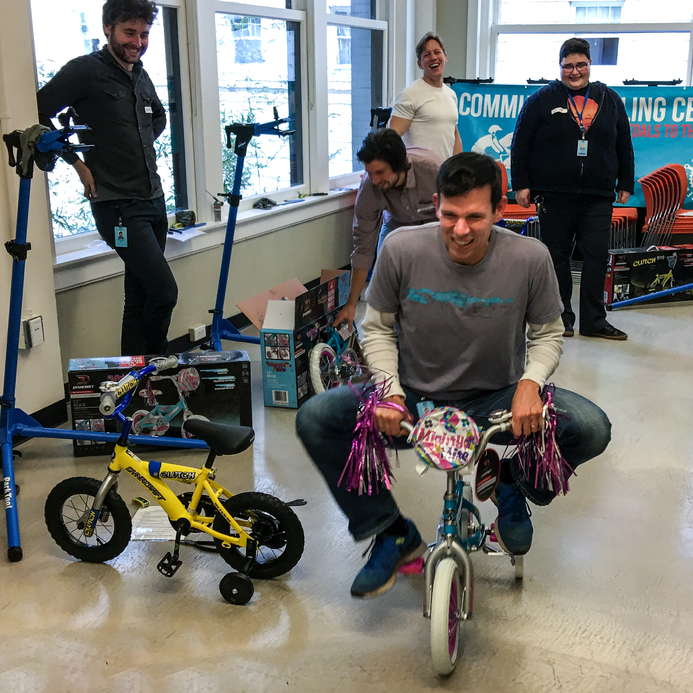 Sam Blackman testing a small children’s bicycle inside the Community Cycling Center