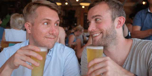 Kris Croucher, left, and Sam Booth, right, holding beers in Sydney