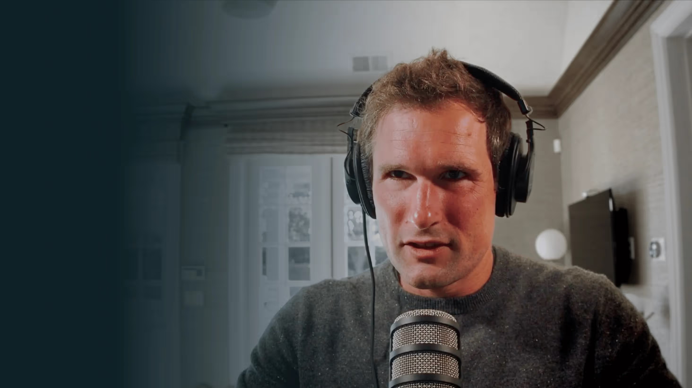 Sam Lessin wearing headphones and speaking into a microphone during his Invested interview