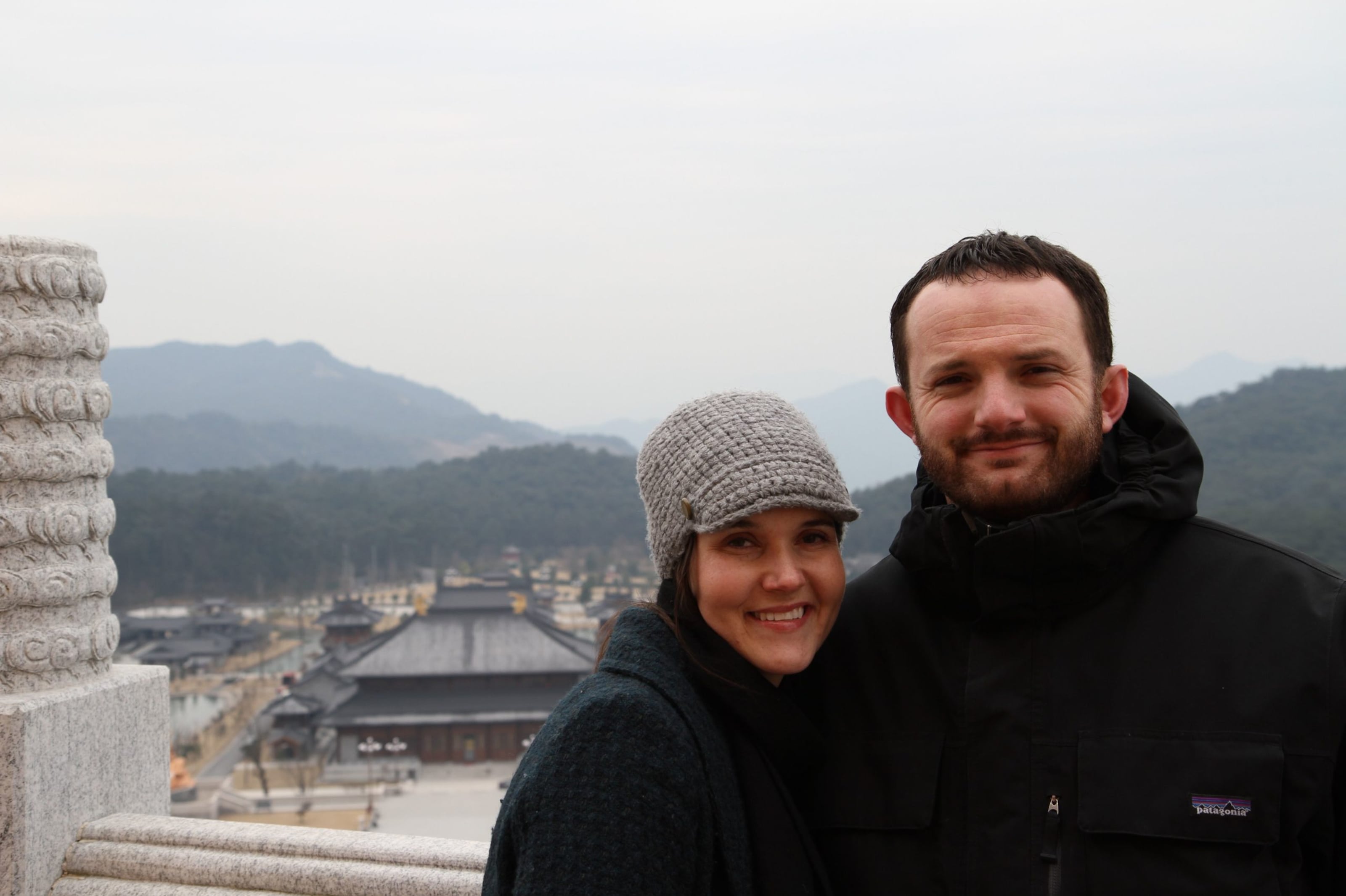 Sam and Kacie Malouf standing together outdoors in an archival photograph