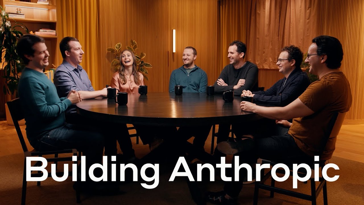 Anthropic's seven co-founders, including Sam McCandlish at center, talking around a round table