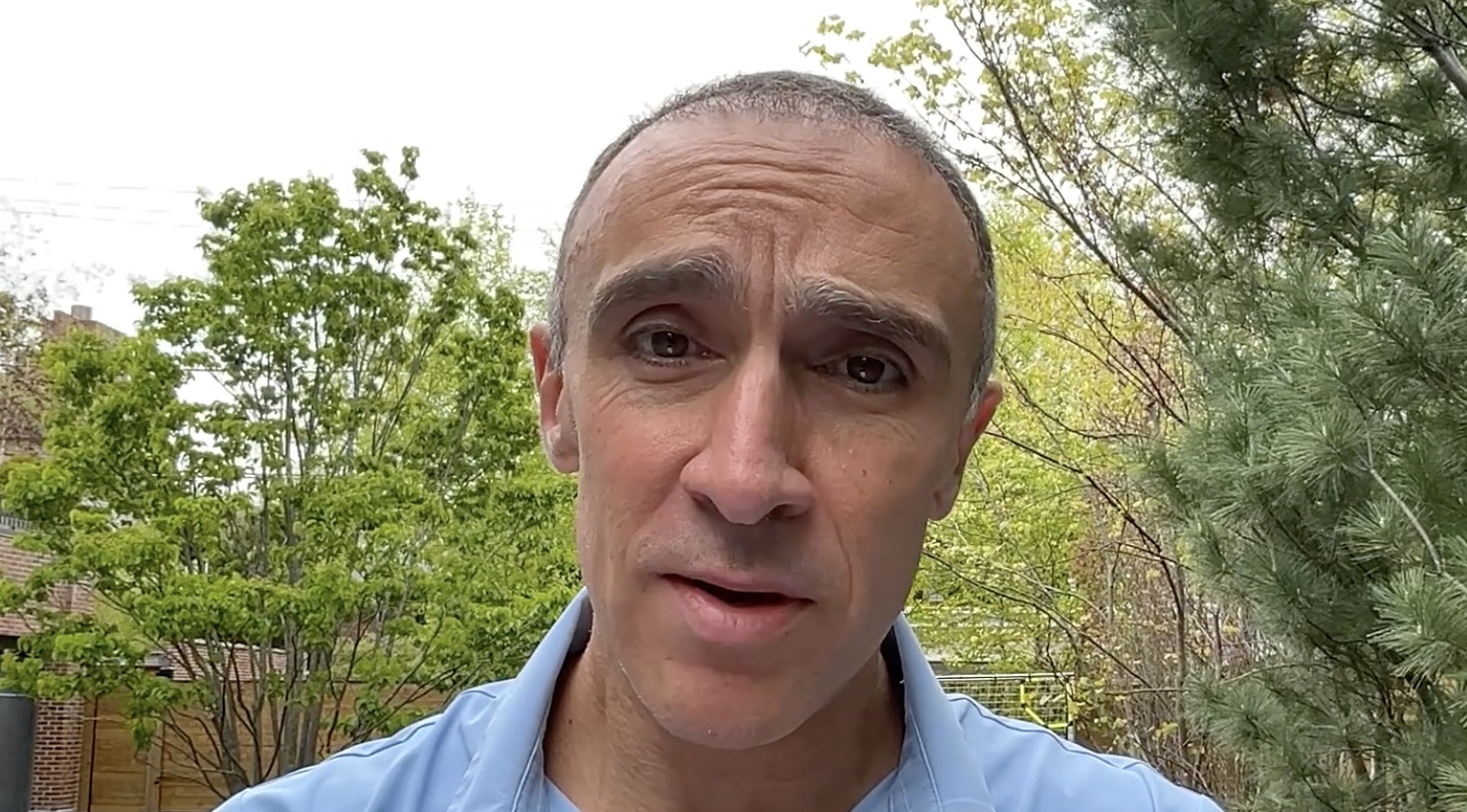 Sam Yagan speaking outdoors in a video about educational opportunity in Illinois