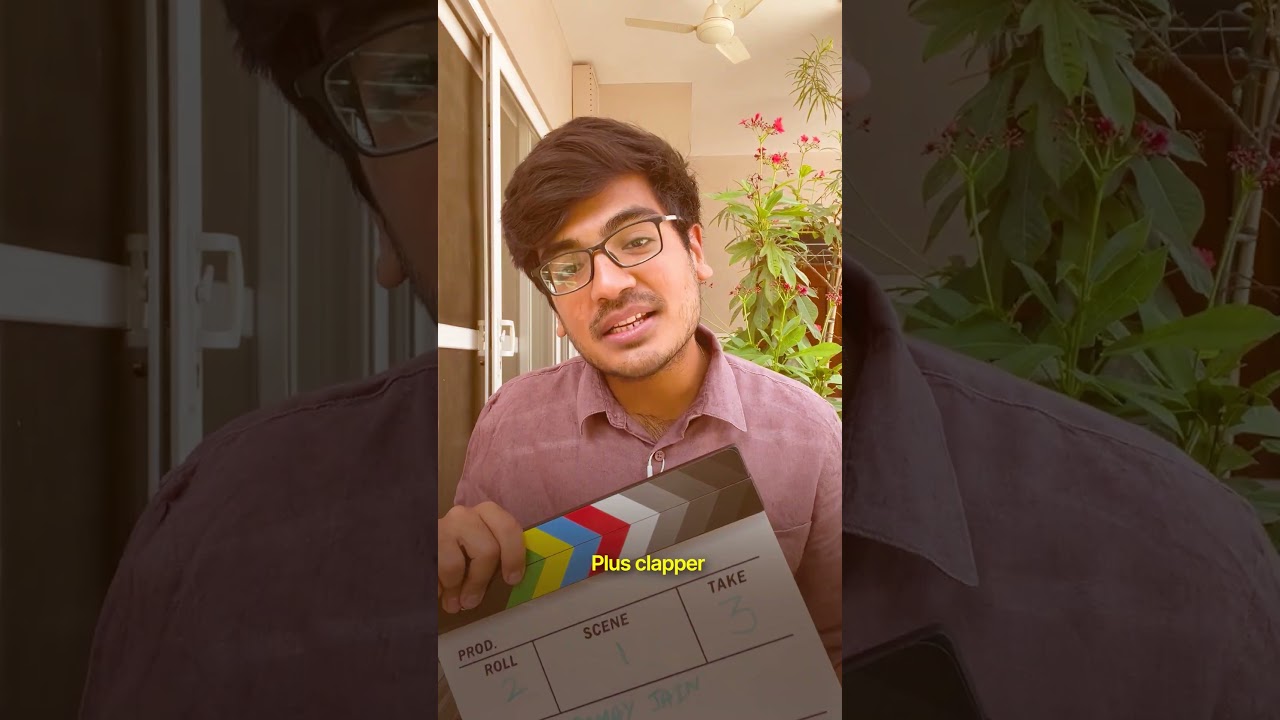 Samay Jain holding a film clapperboard while presenting a YouTube short