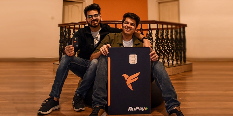 Kush Taneja, left, and Sambhav Jain, right, with a large FamPay RuPay card display