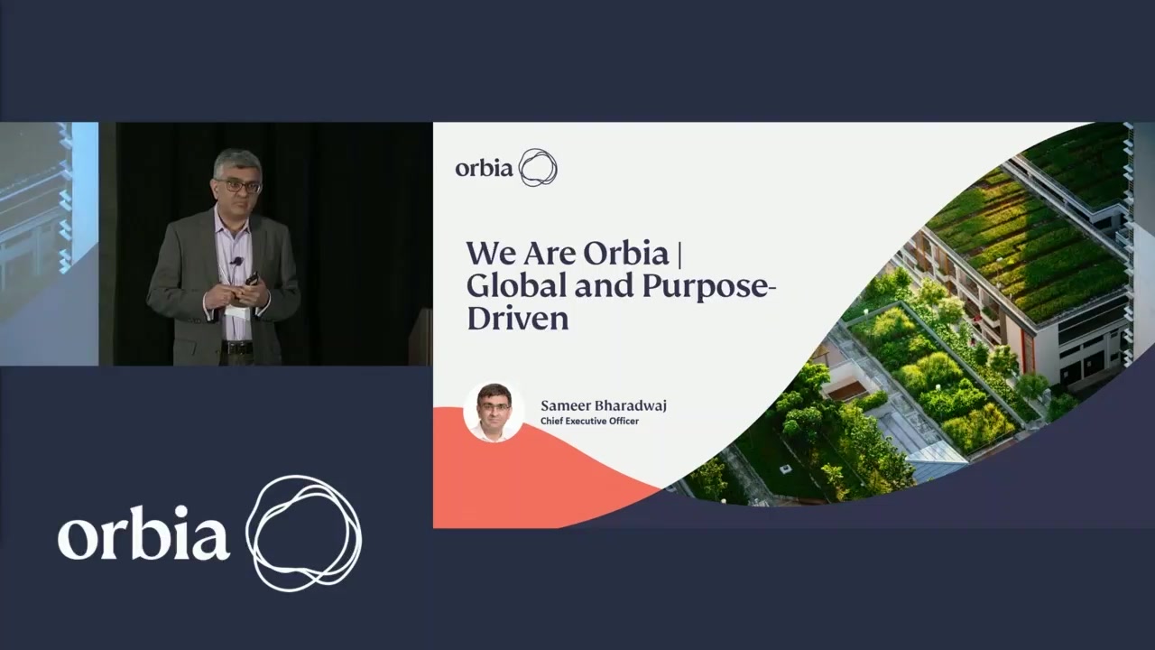 Sameer Bharadwaj presenting beside a slide at Orbia’s 2022 Investor Day in Boston