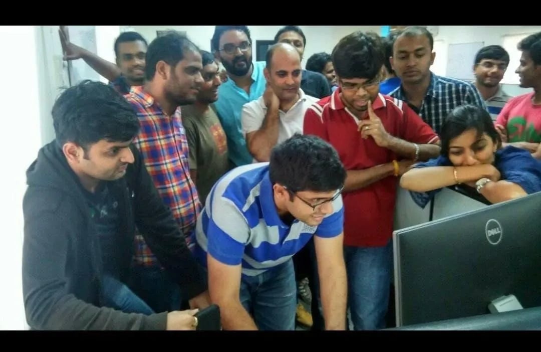 The PhonePe launch team gathered closely around a desktop monitor in 2016