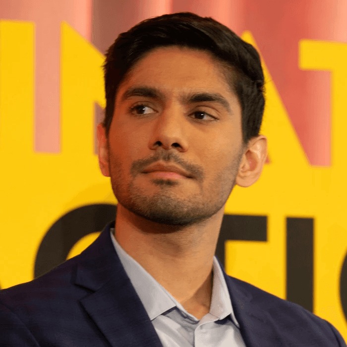 Samir Dutta at a Farsight event, wearing a navy jacket against a yellow and red backdrop