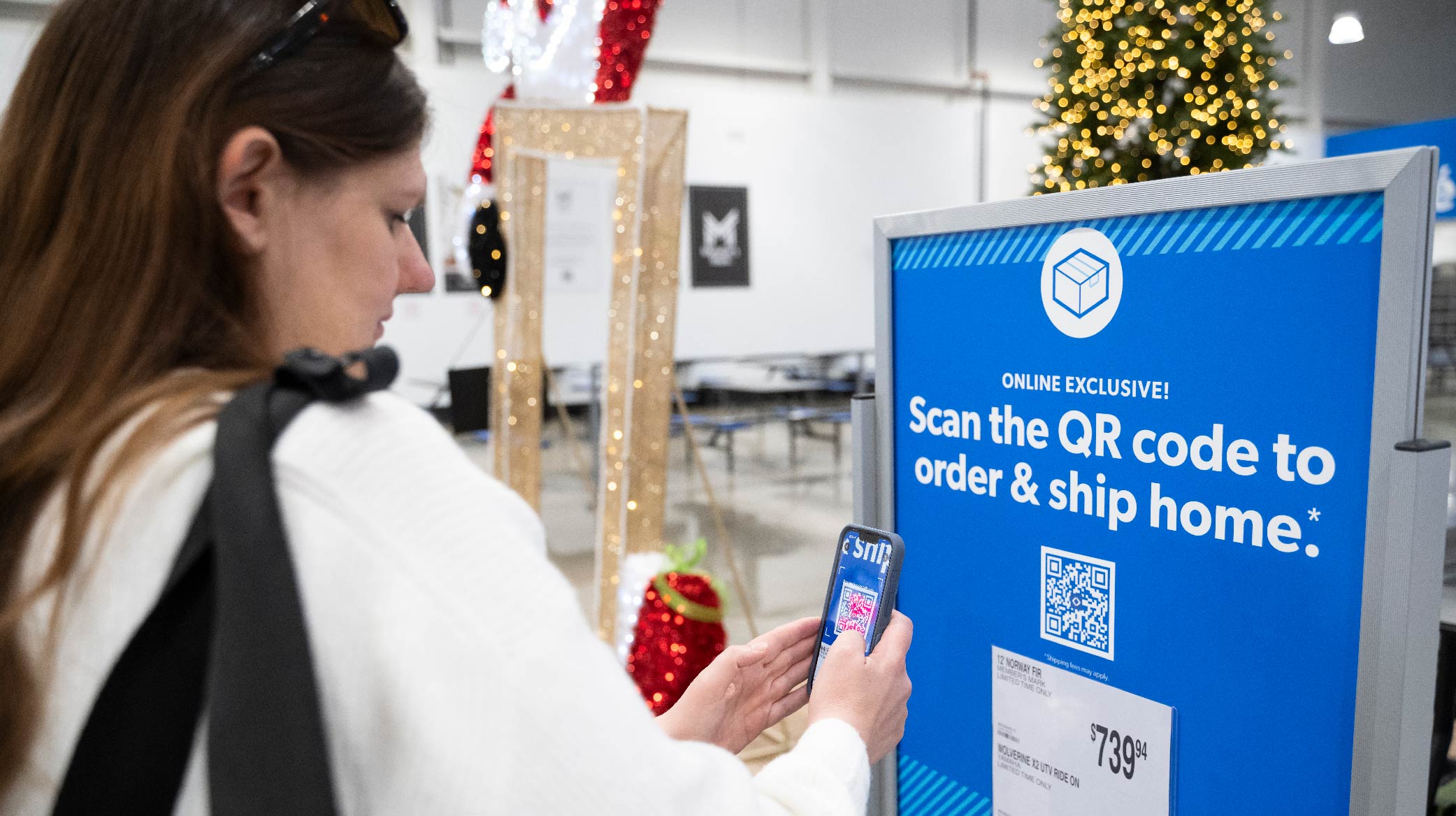 A shopper scans an online-exclusive display with the Sam's Club mobile app inside the Grapevine club
