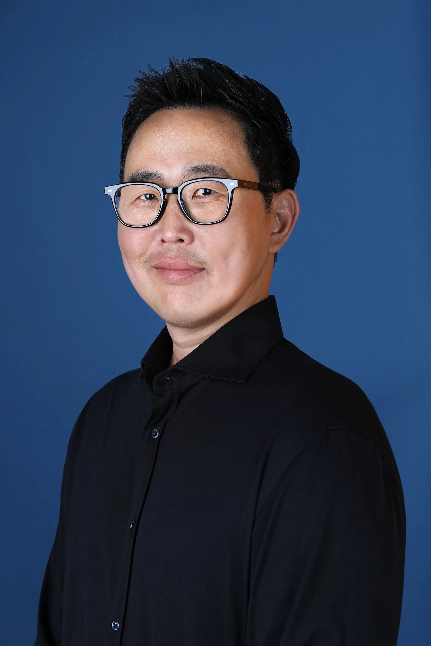 David Lee, head of Samsung Next, wearing glasses and a dark shirt against a blue background