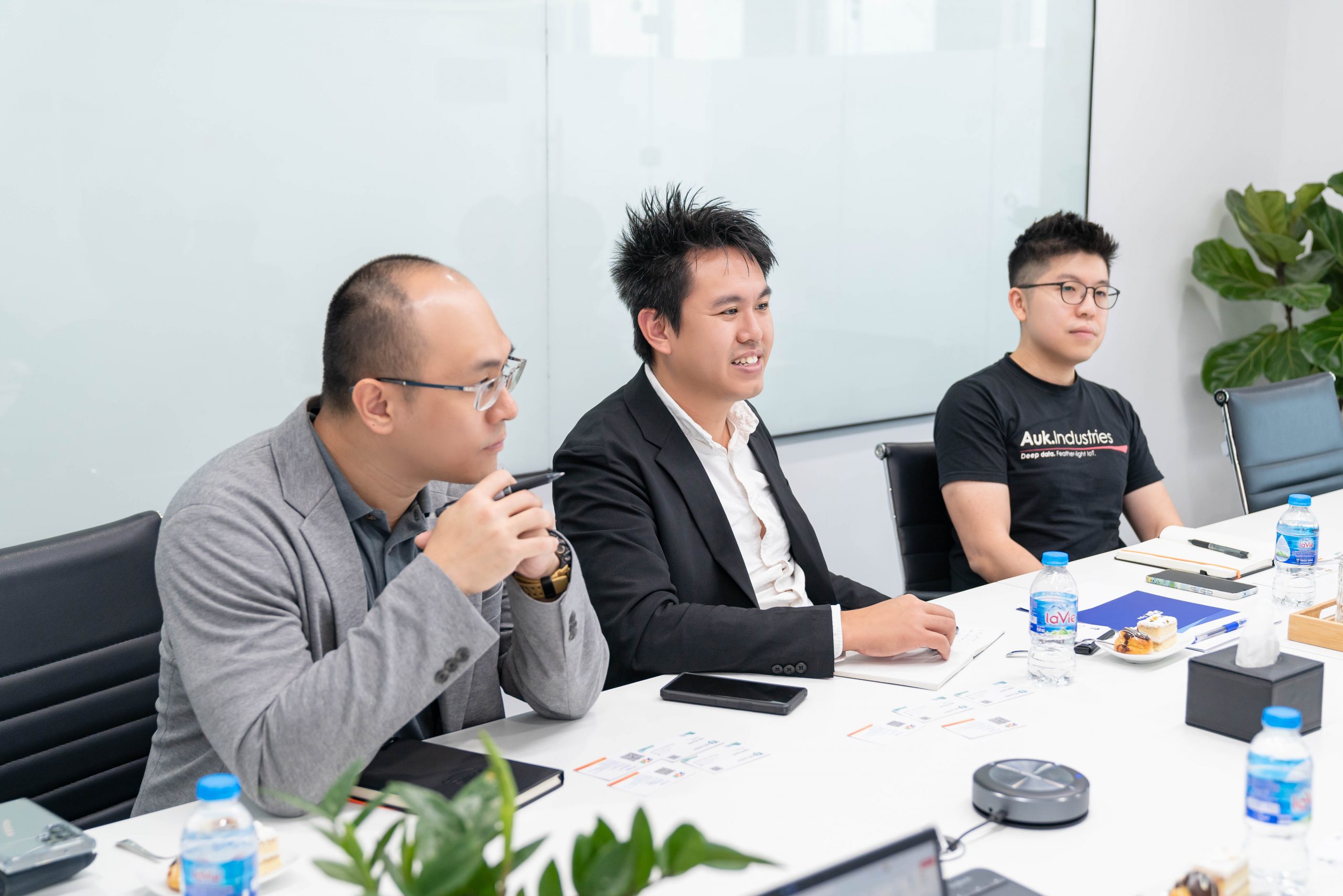 Samuel Tan seated at the centre of an Auk Industries delegation during discussions with FPT Digital