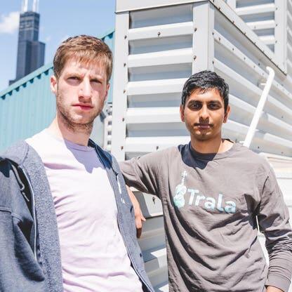 Sam Walder and Vishnu Indukuri standing together on a Chicago rooftop