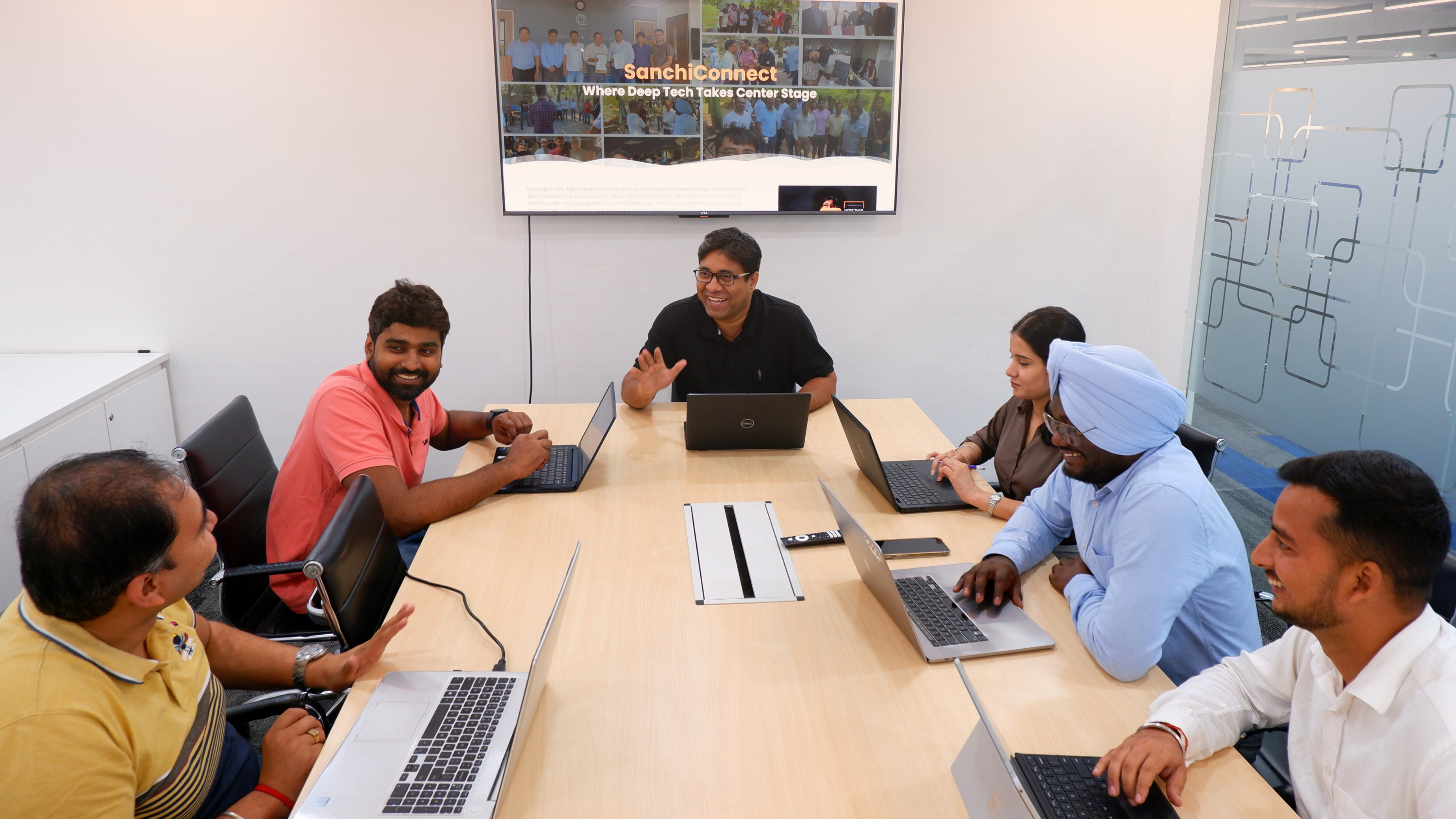 SanchiConnect colleagues in a meeting at the Noida office