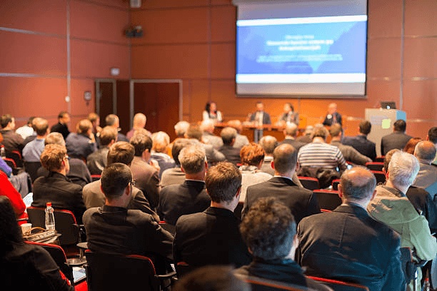 An audience facing a panel in a conference room, an illustrative photograph used on UK Launchpad’s website