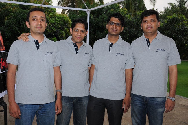 Four members of the early InstaSafe team in matching grey company polo shirts, with Sandip Kumar Panda at the right