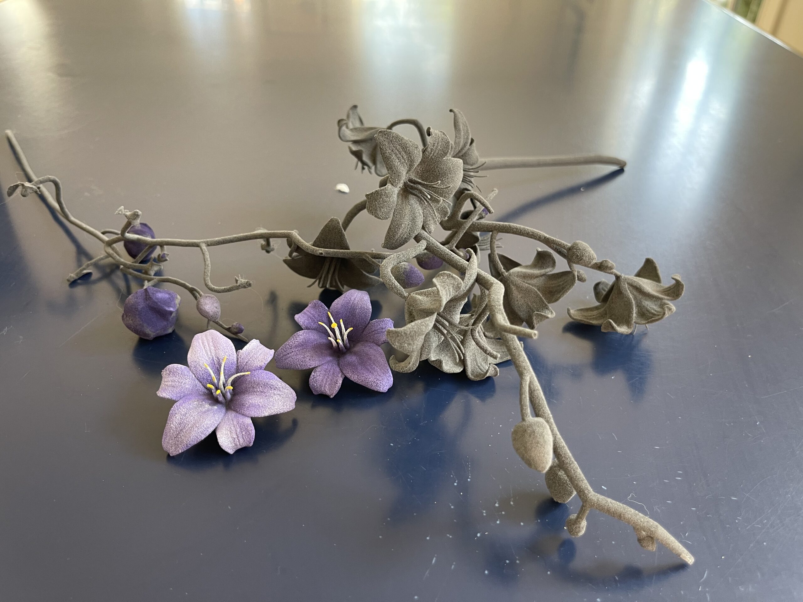 Hand-painted purple flowers and branching 3D-printed floral forms from Sandra Ferguson’s Karlaah Atelier work