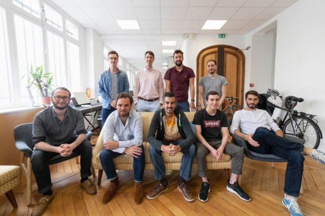 Forest Admin colleagues in an office, with Sandro Munda seated at the centre of the front row.