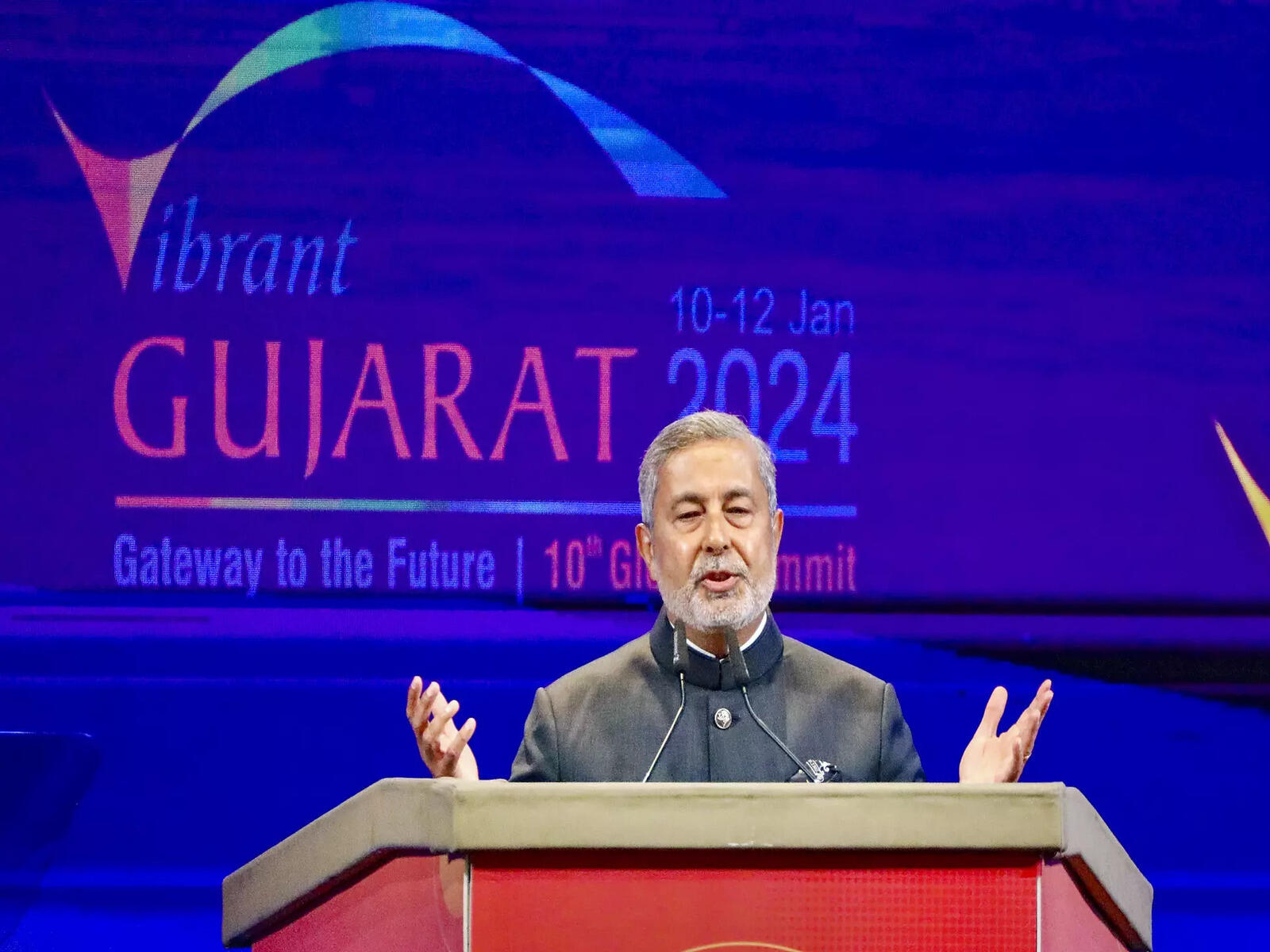 Sanjay Mehrotra speaking at a lectern at the Vibrant Gujarat Global Summit in 2024