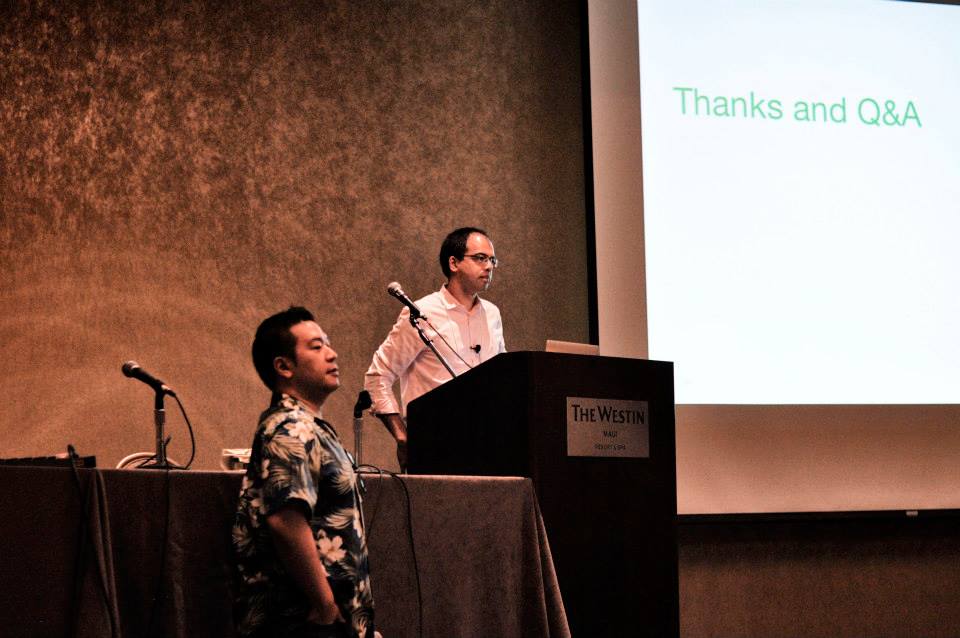 Sanjit Biswas standing at the lectern beside MobiCom chair Sung-Ju Lee in 2014