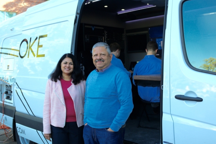 Uma and Jay Jayaram standing beside a VOKE production vehicle