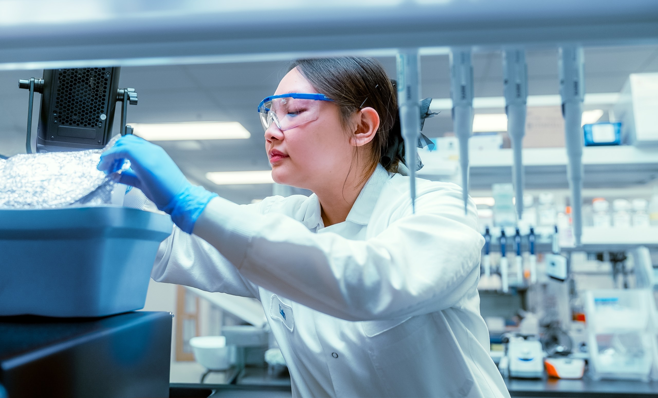 Scientist working with laboratory equipment in a Santa Ana Bio image
