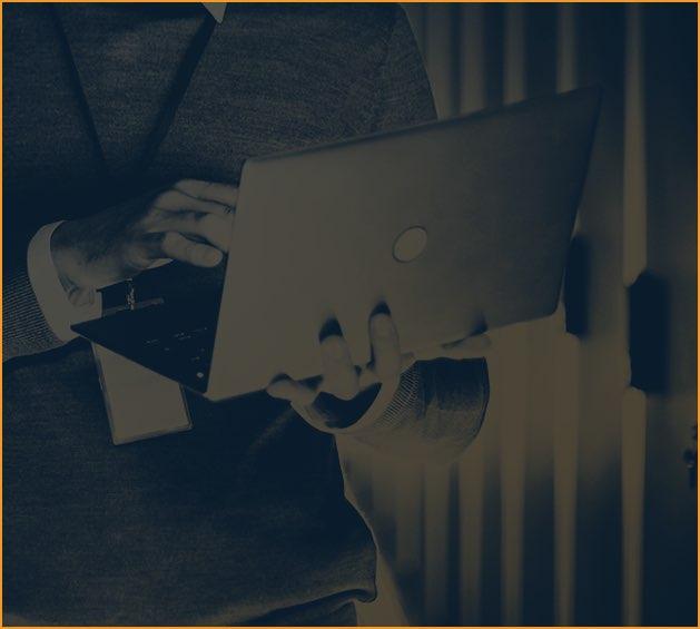 A person holding a laptop in an illustration published by NS2 Serves