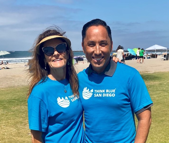 Sara Katz, left, wearing a Think Blue San Diego shirt alongside another participant near the beach