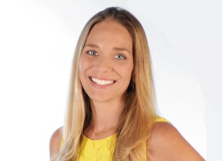 Sarah DeCiantis in a yellow top at the time of her 2017 promotion to chief marketing officer