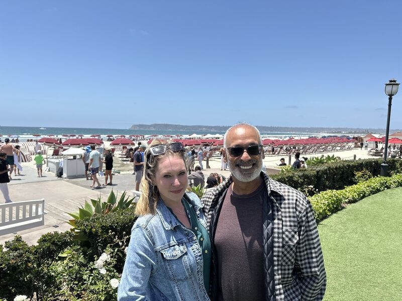 Sarah Jenkins and Vik Verma standing together beside the beach in San Diego