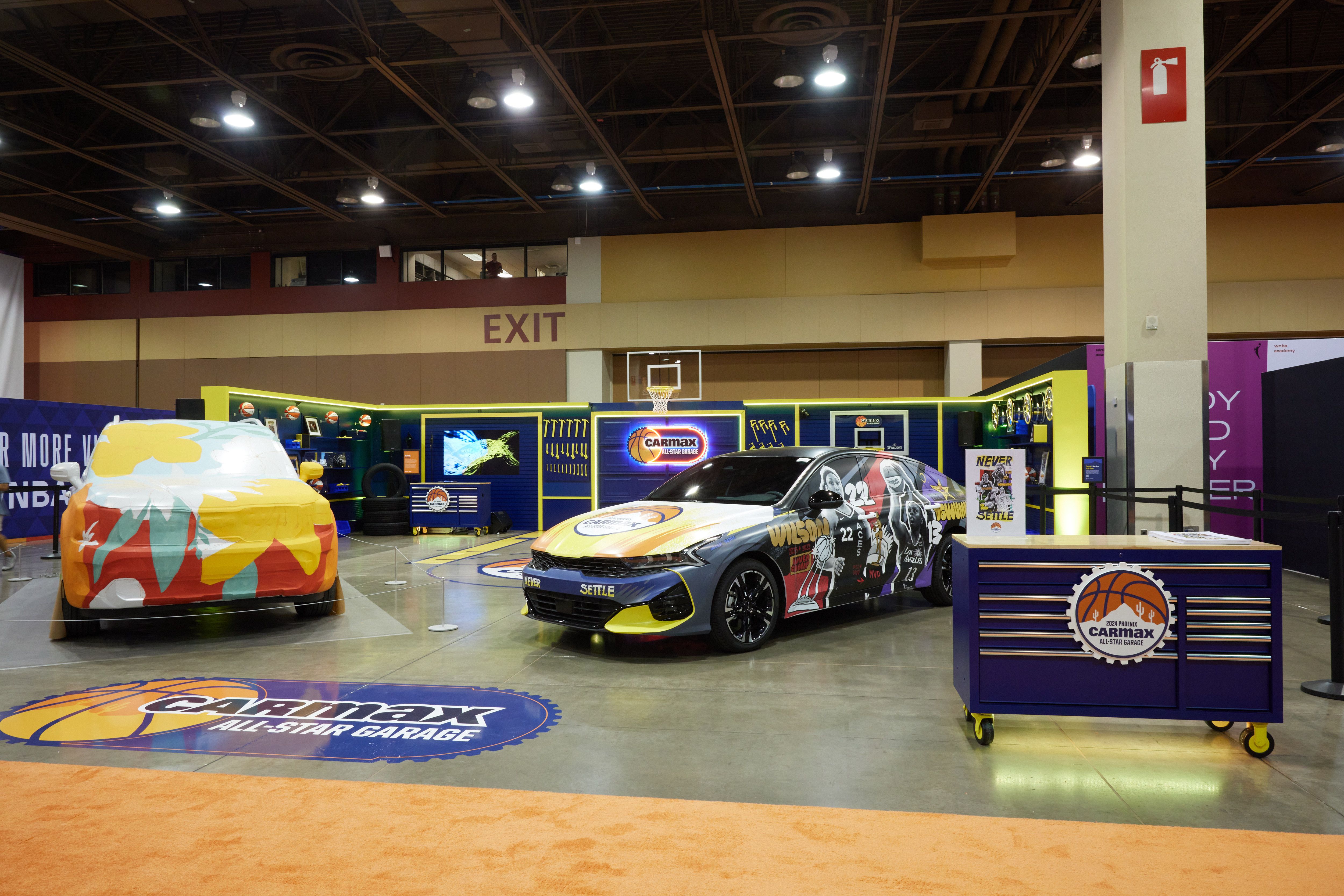The CarMax All-Star Garage activation at WNBA All-Star Weekend in Phoenix, with two art-wrapped cars and a basketball-themed workshop display