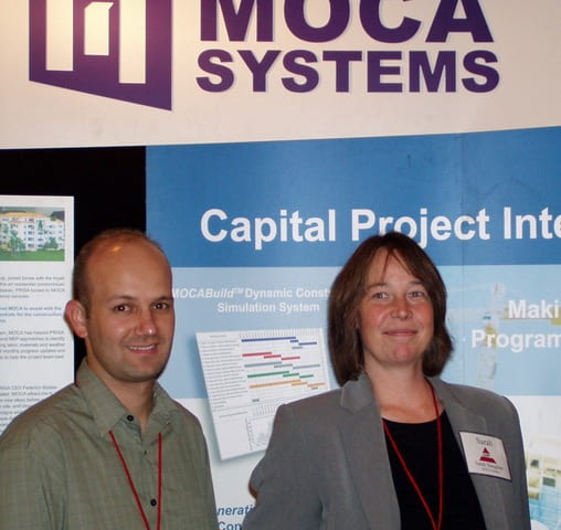 Michael Carr, left, and Sarah Slaughter, right, standing at a MOCA Systems conference booth in 2005