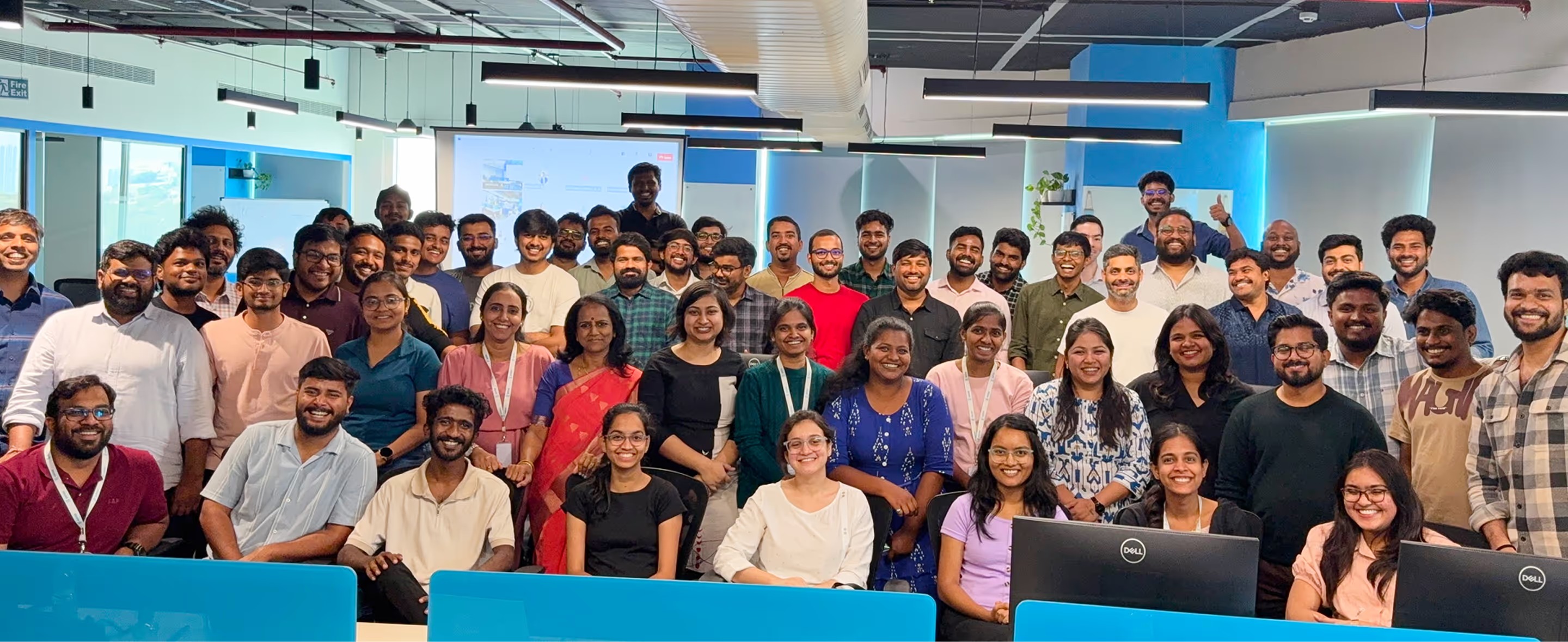 Saras Analytics employees gathered together in an open-plan office