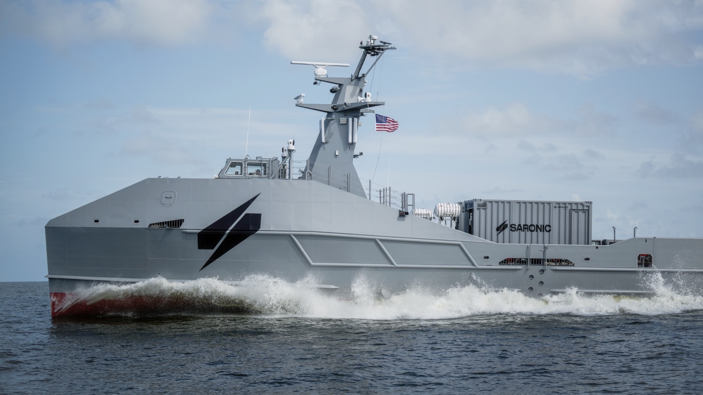 Marauder underway carrying shipping containers under a cloudy sky