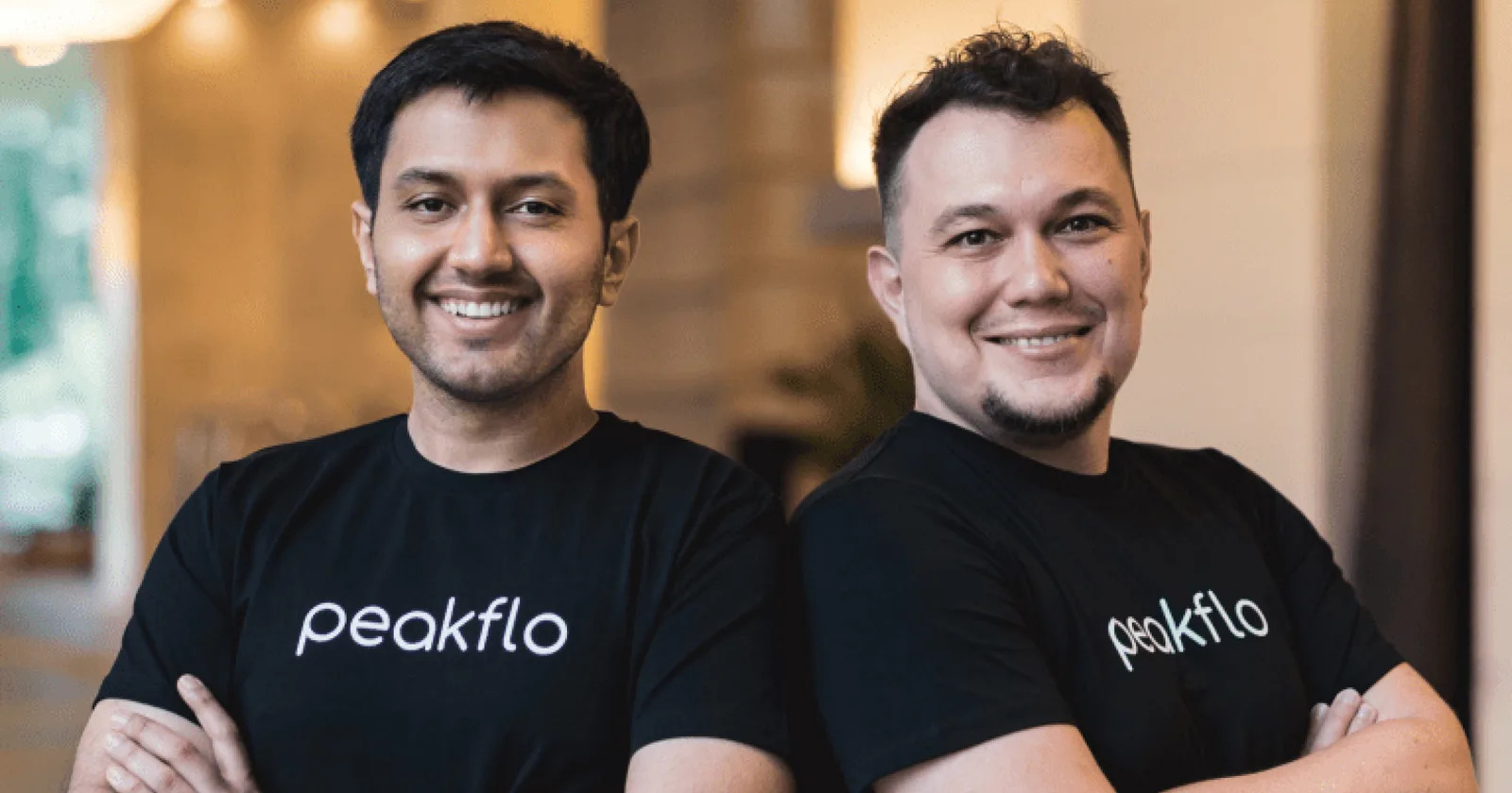 Peakflo co-founders Saurabh Chauhan and Dmitry Vedenyapin wearing Peakflo shirts