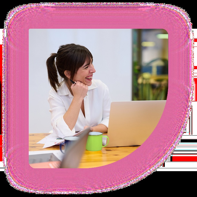 Careers-site promotional photograph of a woman smiling beside a laptop