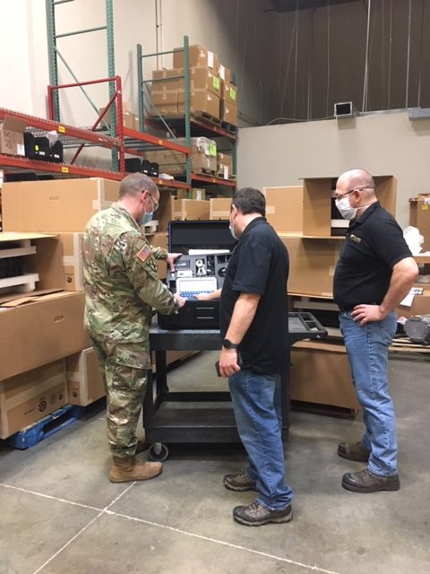 Army National Guard, Savi and First Source Electronics representatives inspecting portable deployment kits