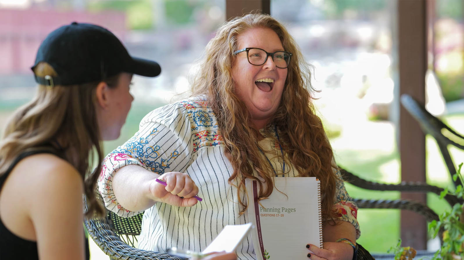 Two participants laugh together during a Schnake leadership planning session