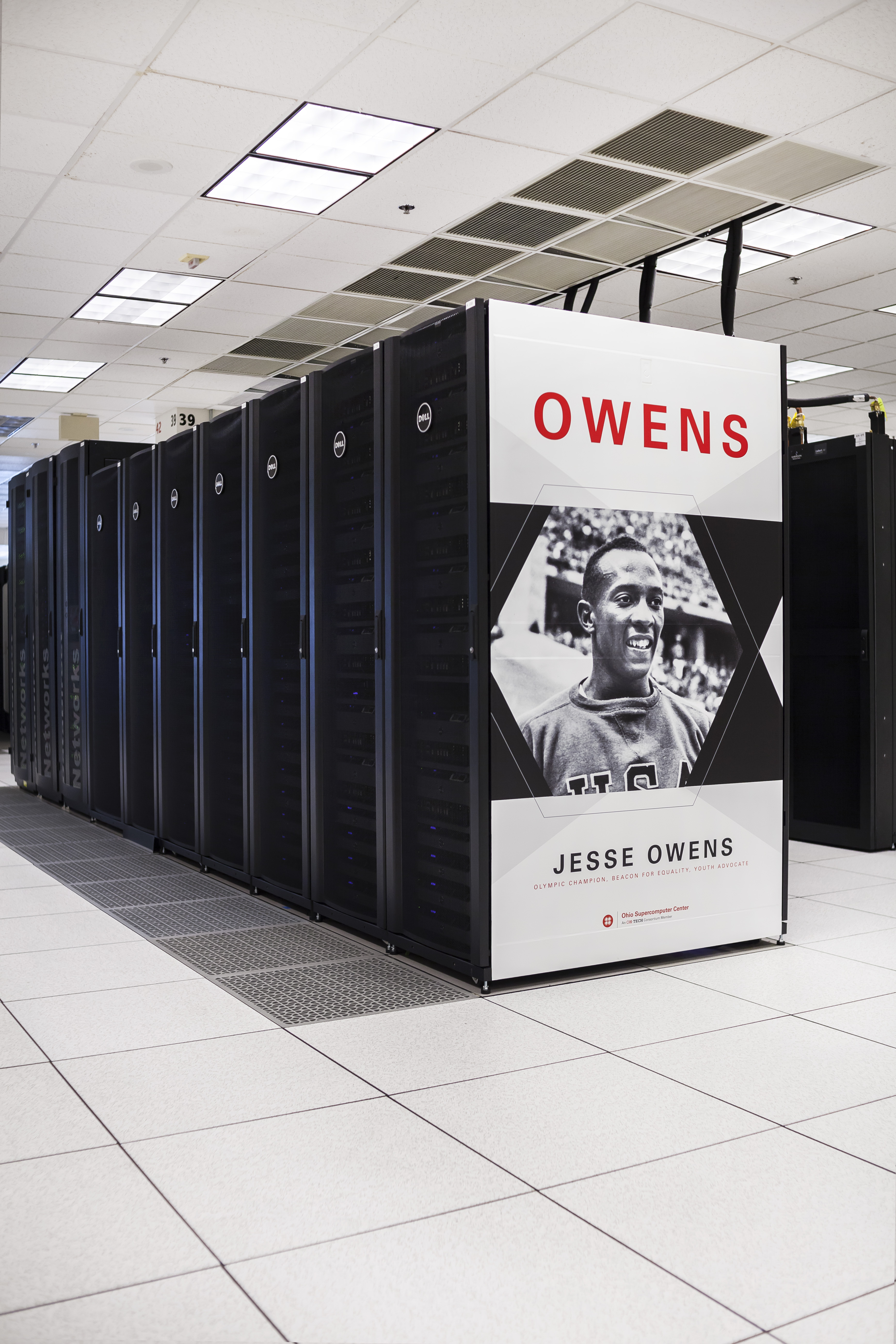 The Owens supercomputer’s black server cabinets and Jesse Owens end panel at the Ohio Supercomputer Center